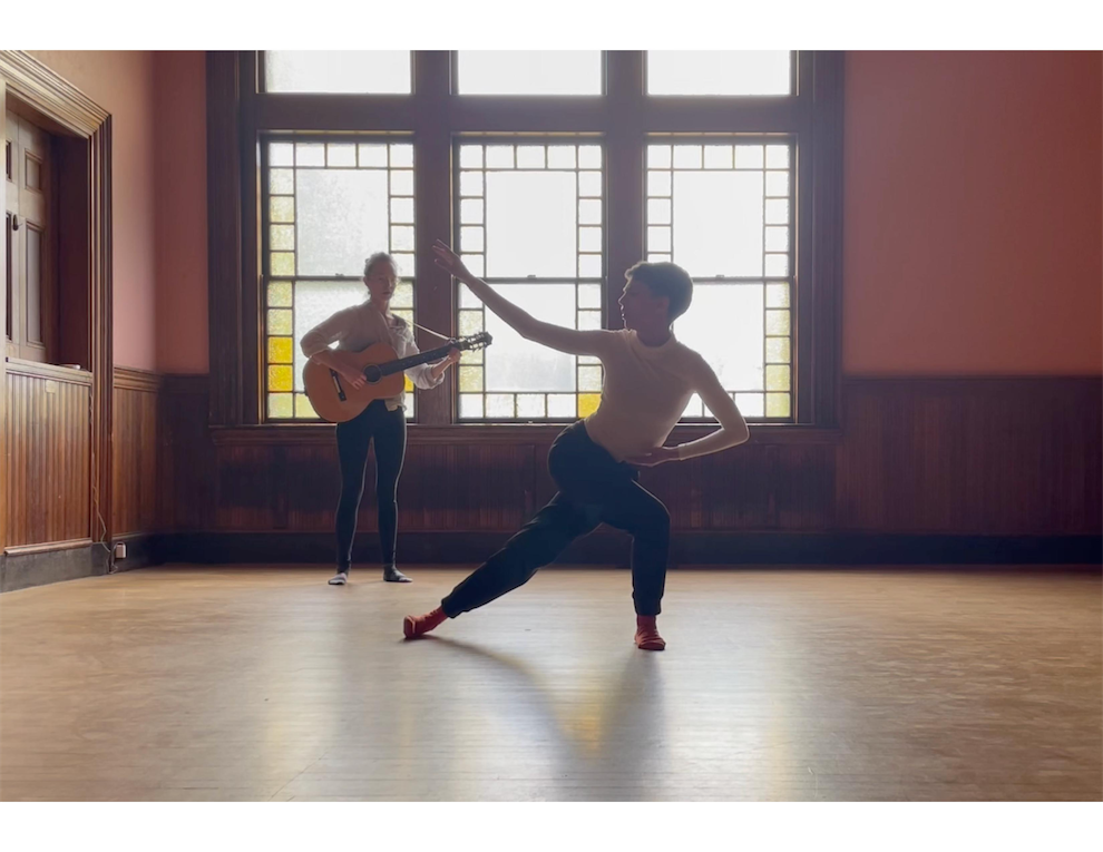a dancer and a musician performing in the Dining Room portion of the Parish Hall