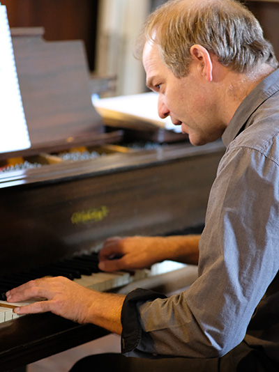 a portrait of Andrei as he play the piano during service