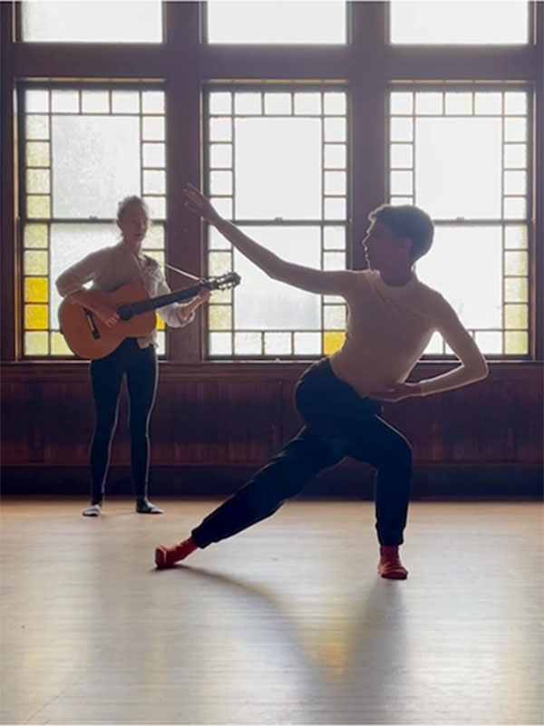 a musican and a dancer performing in the Dining Room portion of the Parish Hall