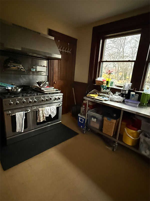 a view of the commercial range, ovens, and work area in the Parish Hall kitchen