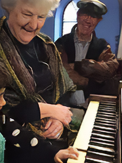 Ellen at the piano with friends